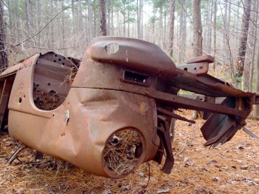 A flipped car, circa 1950, sits trailside as a reminder of the area's past.