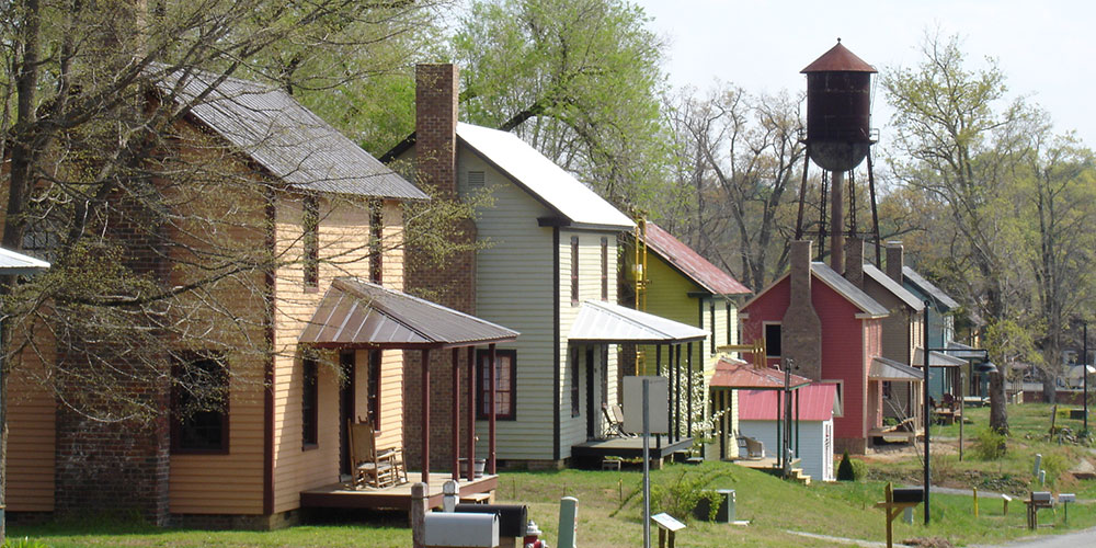 Restored mill houses line the streets in Glencoe along the MST on the Haw River. | Photo © Preservation NC
