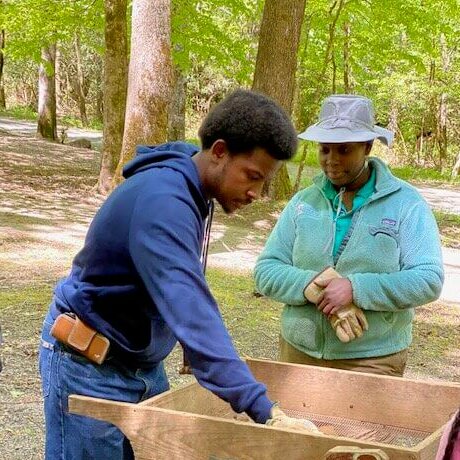 Dr. Rashida Farid observes Tuskegee University student as they assist GSMNP archeology team